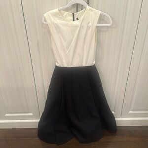 White and black 3/4 length color black sleeveless dress.